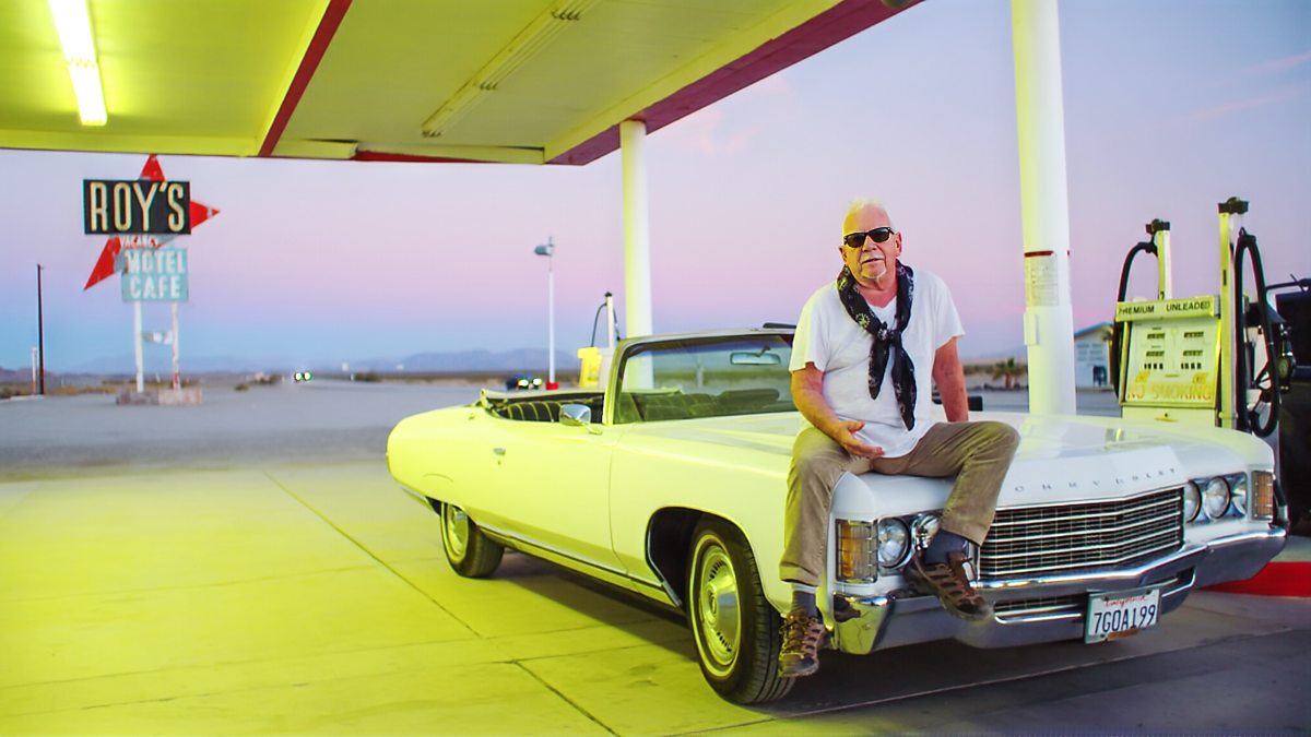 Eric Burdon with a convertible at Roy’s Motel and Café